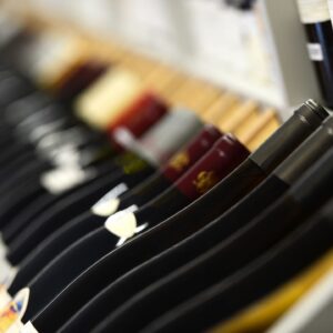 Close-up of wine bottles arranged on a rack.